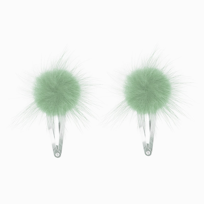 Pair of mint green fur pom pom hair clips